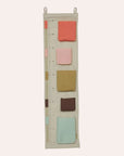 OYOY Mini Saga Growth Chart Storage in Rose with milestone markers and storage pockets