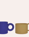OYOY Mini Nomu silicone kids cups two pack in Blue and Caramel with easy-grip handles